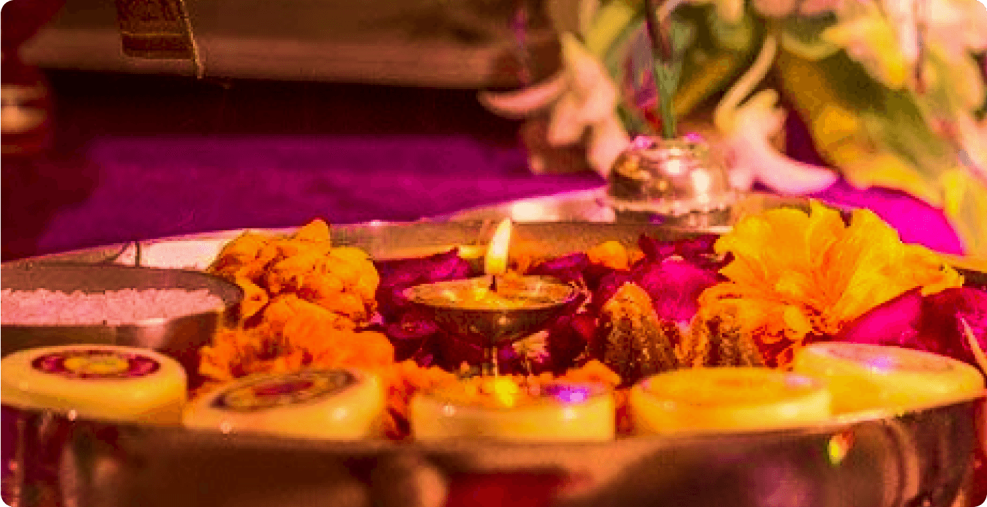 Puja ceremony with flowers and candles